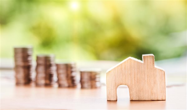 1canva---miniature-house-and-piled-coins